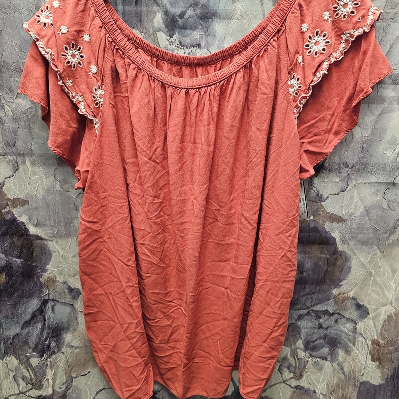 Cute boho style blouse in orange with white embroidery on the ruffled sleeves