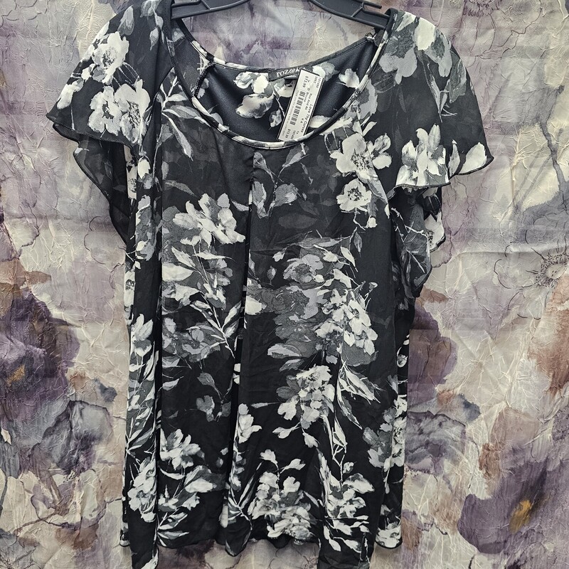 Black blouse with short sleeve and grey floral print.
