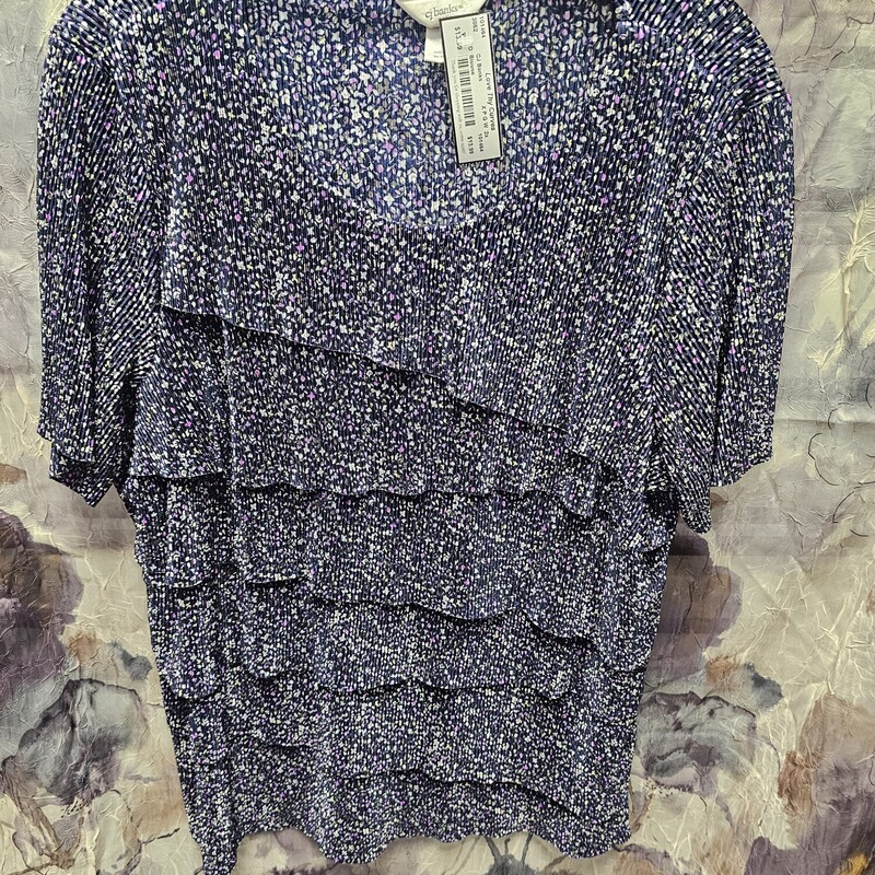 Short sleeve pleated material blouse in navy with small purple green and white floral print.