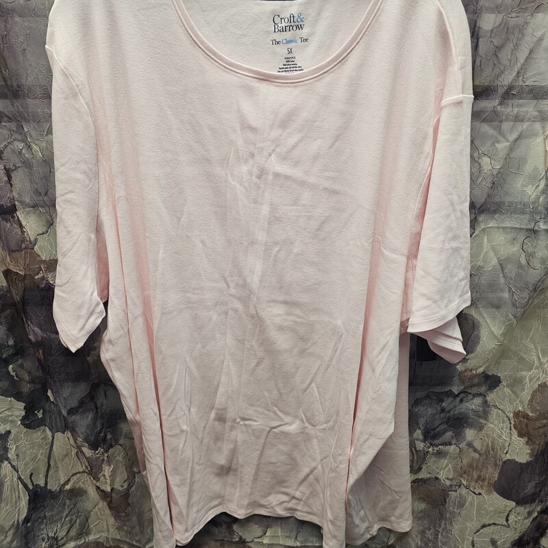 Short sleeve tee shirt is light pink.