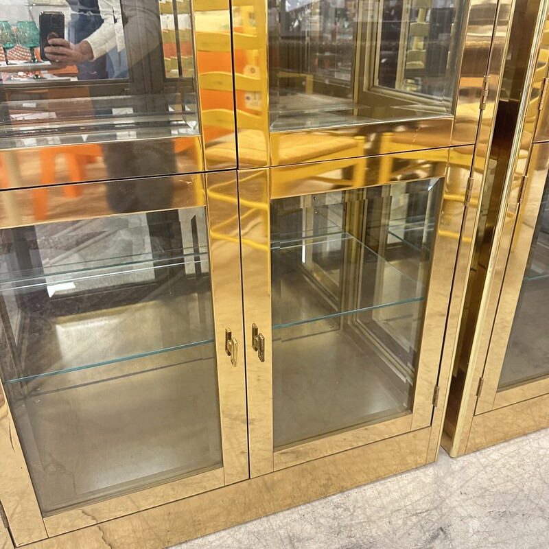 Stunning Mastercraft Brass Cabinet/Vitrine, Wood with Brass Overlay. Glass shelves with interior lights; mid century modern style. Price is for ONE cabinet.<br />
Size: 32W × 16D × 84H