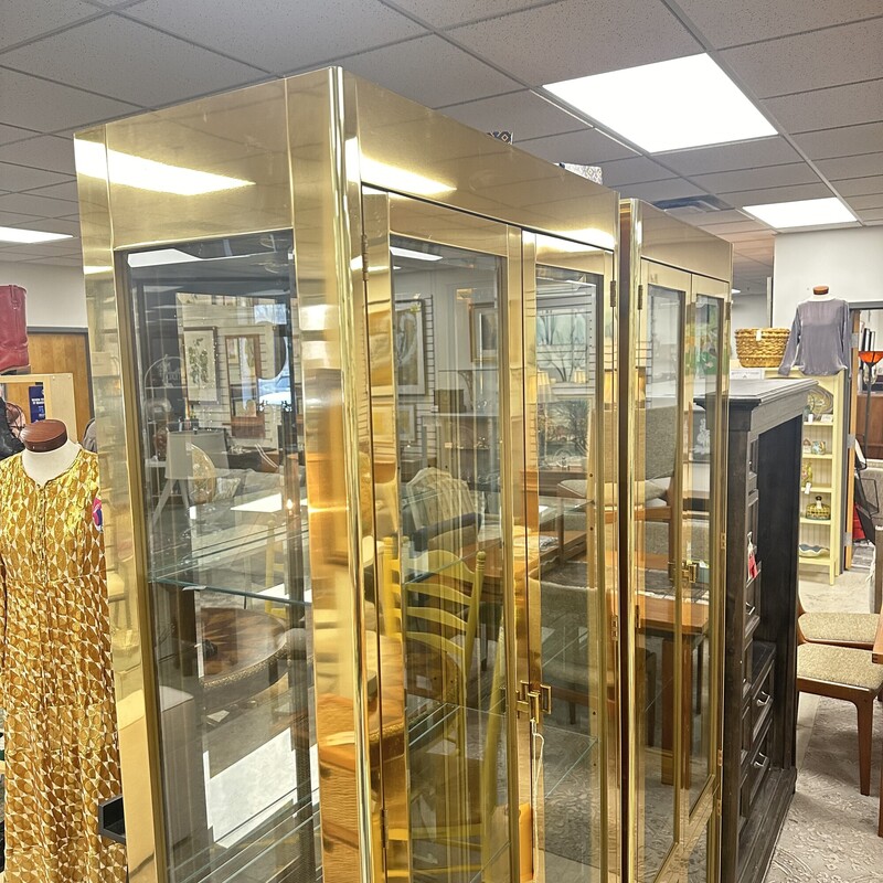 Stunning Mastercraft Brass Cabinet/Vitrine, Wood with Brass Overlay. Glass shelves with interior lights; mid century modern style. Price is for ONE cabinet.<br />
Size: 32W × 16D × 84H