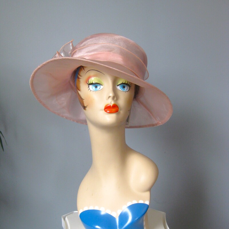 Perfect for a summer special ocassion, a visit to the track or a special Sunday Church event
this is a brand new with tags organze hat by Josette
It's pale peach pink, with a wide brim and a pretty bow at the crown.
So lightweight and easy to keep on the head
Crisp and sturdy.

The diameter of the hat is 14
and the inside circumference is 22.25

perfect brand new condition.
Thanks for looking!
#70975