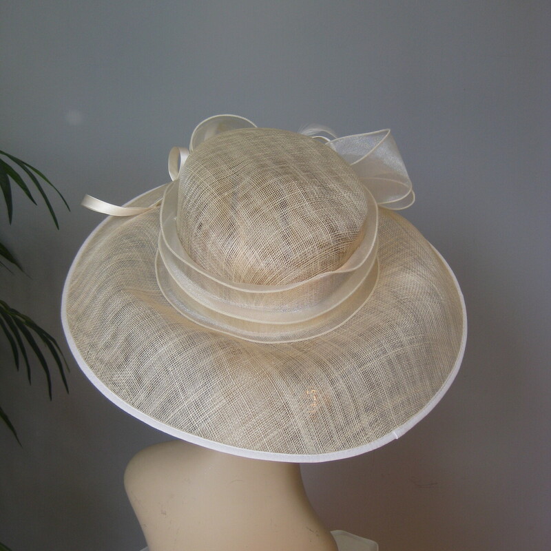 Perfect for a summer special ocassion, a visit to the track or a special Sunday Church event<br />
this is a brand new with tags organza hat by Josette<br />
It's ivory or cream, with a wide brim tiers of ribbons around the crown and finished with a fancy bow<br />
So lightweight and easy to keep on the head<br />
Crisp and sturdy.<br />
<br />
the inside circumference is 22.<br />
<br />
perfect brand new condition.<br />
Thanks for looking!<br />
#70972