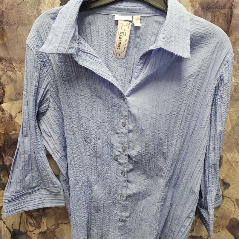 Long sleeve button up blouse in blue. Crinkle material.