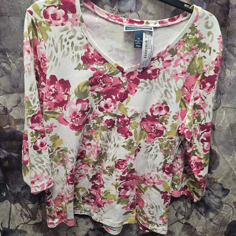 Half sleeve knit top in white with pink and green floral print.