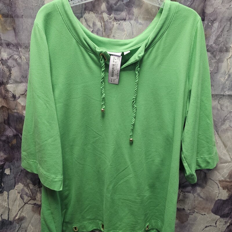 Green half sleeve knit top with rivets in the bottom hem