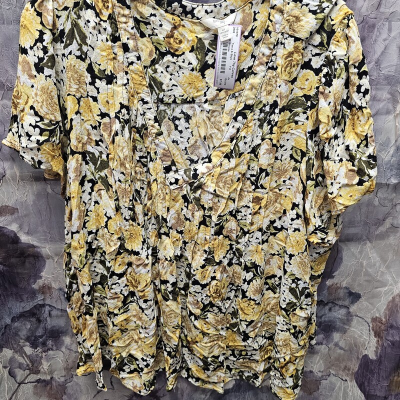 Short sleeve black blouse with yellow floral print.