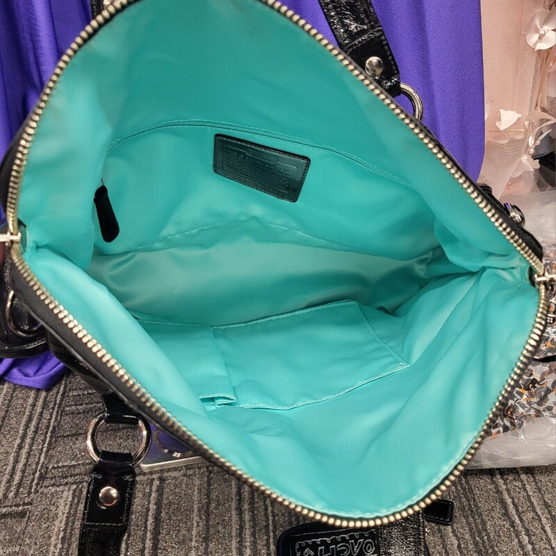 Brand NEW condition Coach Poppy Black Patent Leather Tote Bag & Wristlet Serial Number C0973-13832 Silver hardware, zipper top, 3 small interior pockets, 3 exterior pockets, 2 removable key chain tags, satin aqua interior, 14 x 11 with 3 strap drop