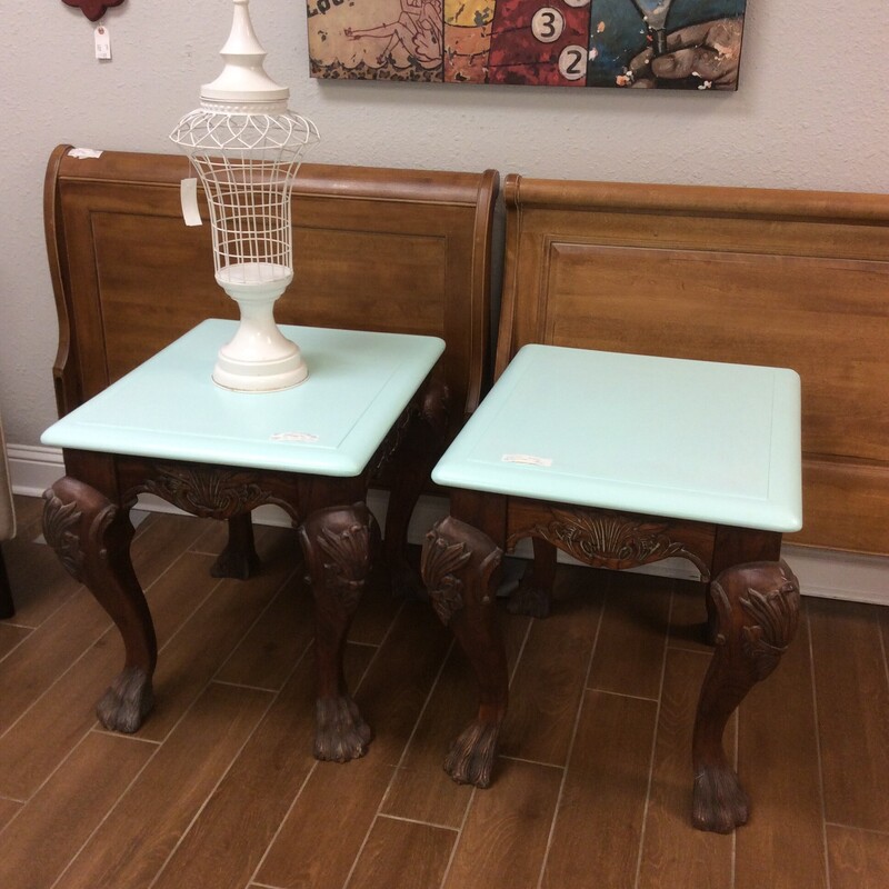 This pair is an interesting combination of dark carved wood and a teal tabletop.