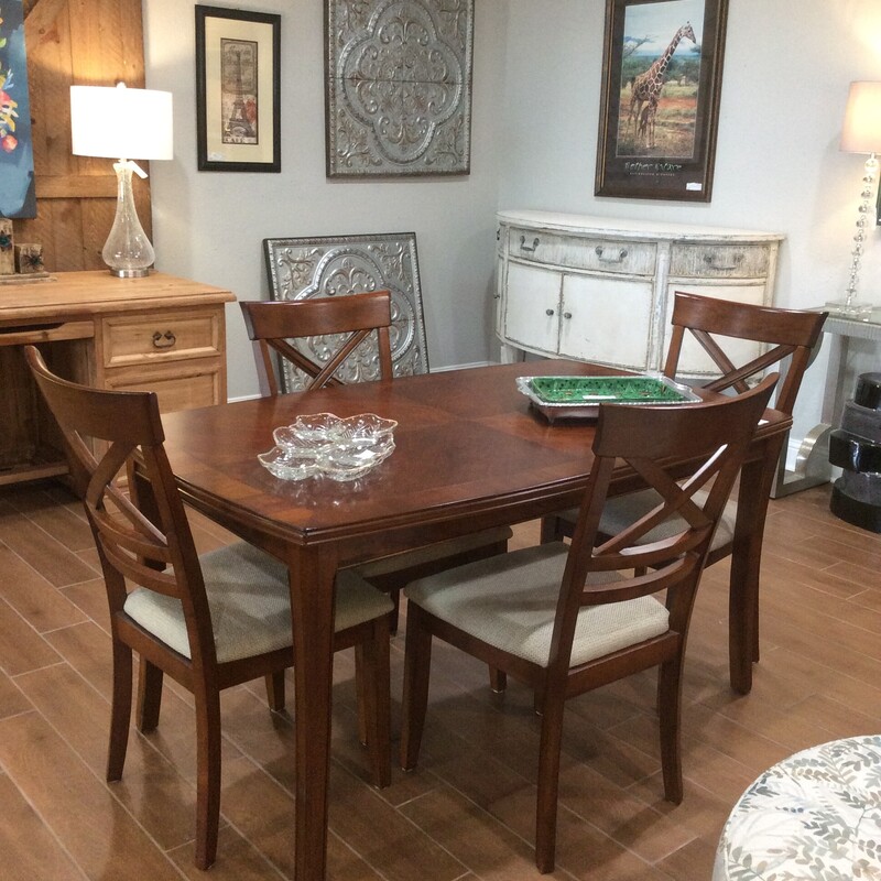 This petite diningroom set would be perfect for breakfast. It has a dark wood finish and comes with 4 chairs.