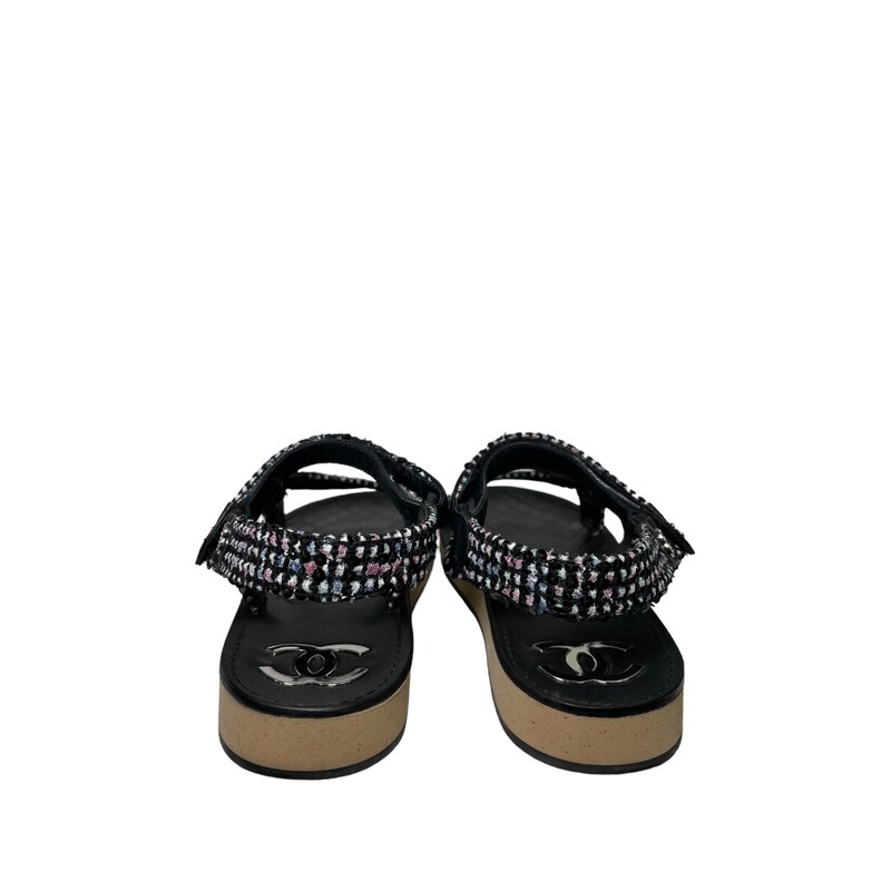 Chanel Lambskin Dad Tweed Black & White<br />
<br />
Size: 38<br />
<br />
This is an authentic pair of Chanel Tweed Lambskin Crystal CC Sandals in  Black and Multicolor. These stylish sandals are crafted of tweed fabric and leather. They feature straps with crystal CC logos.
