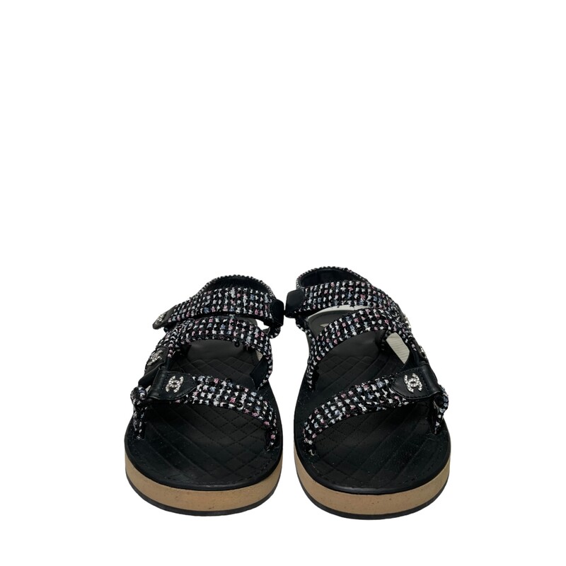 Chanel Lambskin Dad Tweed Black & White<br />
<br />
Size: 38<br />
<br />
This is an authentic pair of Chanel Tweed Lambskin Crystal CC Sandals in  Black and Multicolor. These stylish sandals are crafted of tweed fabric and leather. They feature straps with crystal CC logos.