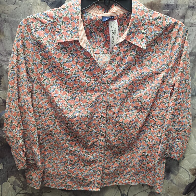 Half sleeve button up blouse in orange green and blue floral pattern.