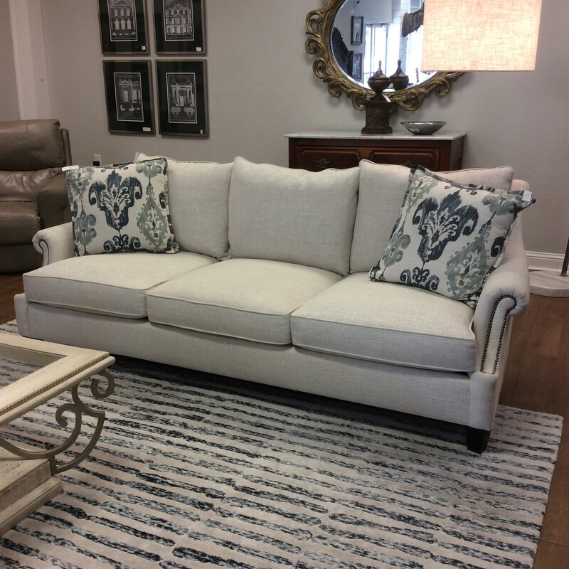Gorgeous! This sofa from Bernhardt Furniture will beautify any room, Tradiitonal in style but totally modern. It's understated beauty. Upholstered in a luscious oatmeal with small rolled arms and a bold nailhead trim. We have 2 of them priced separately. Accessory pillows included.