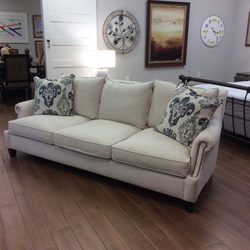 Gorgeous! This elegant sofa from Bernhardt Furniture will beautify any room. Traditional in style but totally modern. Upholstered in a luscious oatmeal with small rolled arms and a bold nailhead trim. Two accessory pillows included. We have 2 of them priced separately.