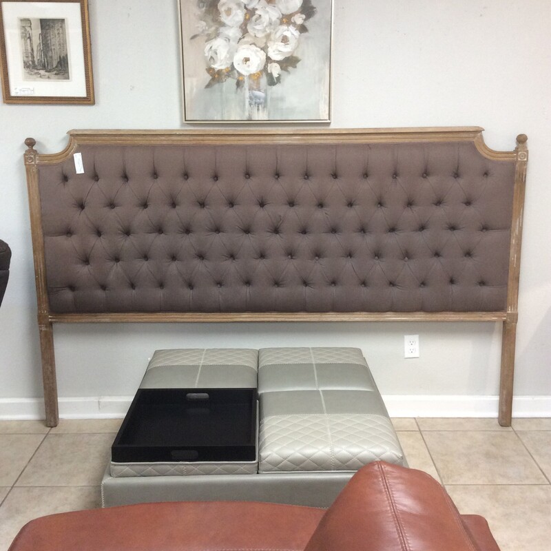Tufted brown king headboard with metal frame.