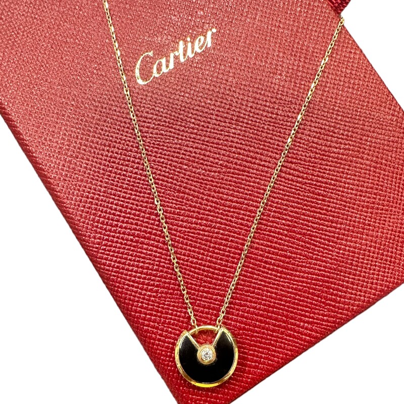 Amulette de Cartier necklace, XS model, 18K rose gold (750/1000), onyx, set with a brilliant-cut diamond of 0.02 carats. Diameter of motif: 12 mm. Adjustable chain: 38-41 cm.