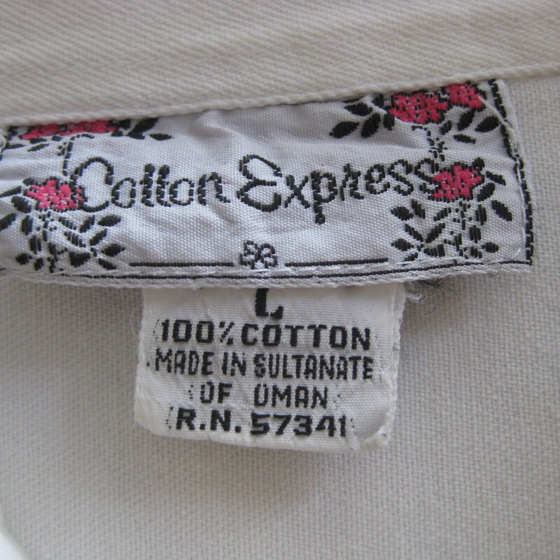 Here is a 100% Cotton Shirt from the 1970s in an white  with decorated collar and pocket flaps.
It's by Cotton Express.
The cotton is sturdy!  Not lightweight.
Curved hem
The studs are gold and the studs are set in gold.
The gold has a fair amount of tarnish as you can see in my closeup photos.
The chest pockets are real pockets
Marked size L which seems accurate for a modern size large person.:
Here are the flat measurements:
Shoulder to shoulder 20
Armpit to Armpit: 24
Width at hem: 23
Length: 27.75

Great condition,  there is a faint yellow mark near the lower buttons and as mentioned there is some tarnish on the gold tone metal studs and settings.

thanks for looking!
#67873