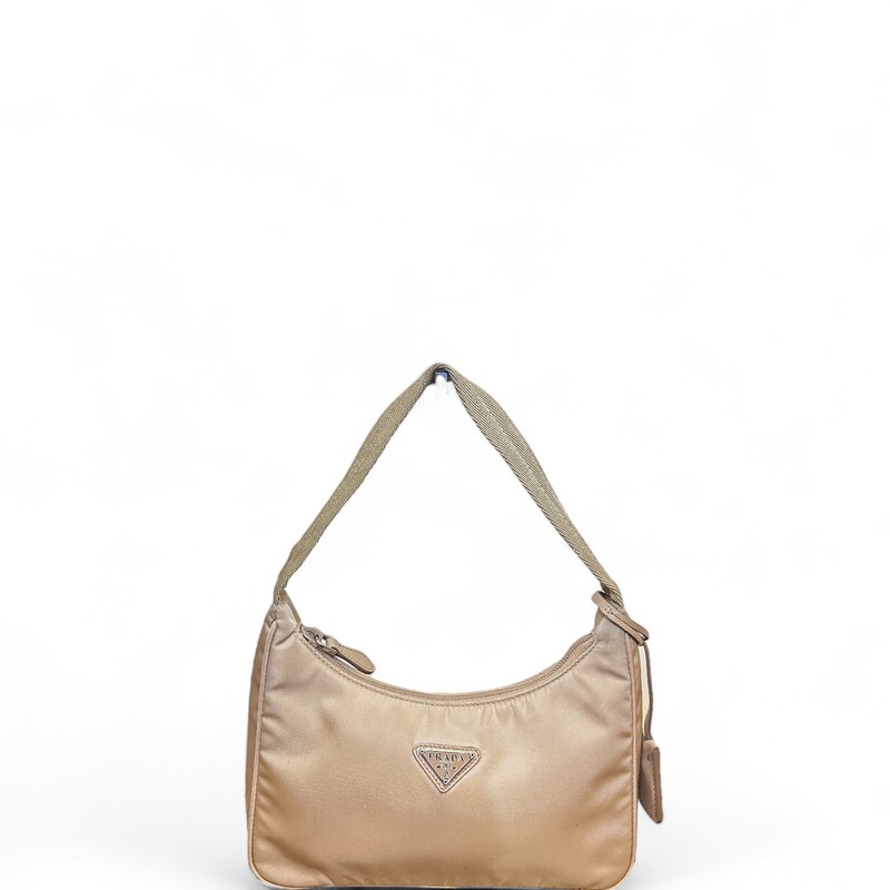 Prada Nylon Mini Re-Edit, Beige, Size: OS

Dimensions:
Height: 17cm
Width: 22cm
Length: 6cm

Note: Light stain on front and bottom of bag.

A new interpretation of an iconic Prada style, the Re-Edition 2000 mini-bag is made of innovative Re-Nylon, produced from recycled, purified plastic trash collected in the ocean, fishing nets, and textile waste fibers. The accessory with zipper closure and woven tape handle is decorated with the iconic enameled metal triangle logo.