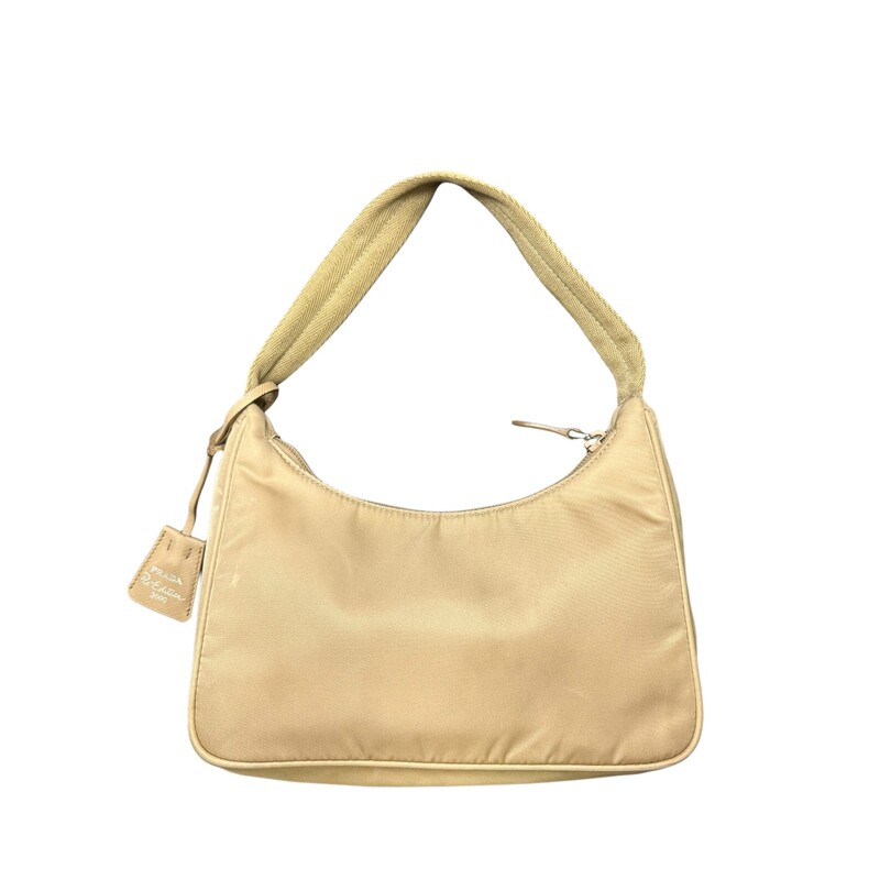 Prada Nylon Mini Re-Edit, Beige, Size: OS<br />
<br />
Dimensions:<br />
Height: 17cm<br />
Width: 22cm<br />
Length: 6cm<br />
<br />
Note: Light stain on front and bottom of bag.<br />
<br />
A new interpretation of an iconic Prada style, the Re-Edition 2000 mini-bag is made of innovative Re-Nylon, produced from recycled, purified plastic trash collected in the ocean, fishing nets, and textile waste fibers. The accessory with zipper closure and woven tape handle is decorated with the iconic enameled metal triangle logo.