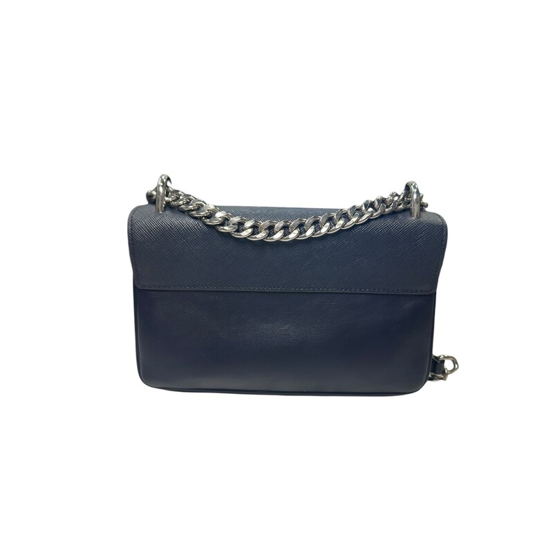 Prada Shoulder Chain, Navy, Size: OS<br />
<br />
Dimensions:<br />
Base length: 7.75 in<br />
Height: 5.00 in<br />
Width: 1.75 in<br />
Drop: 12.00 in or 22.00 in<br />
<br />
This is an authentic Prada Saffiano Chain Shoulder Bag in Navy. This chic crossbody bag is crafted of smooth calfskin leather in black. The bag features a polished silver chain shoulder strap with a leather shoulder pad, a cross grain front flap, and silver hardware. This flap opens to a partitioned black jacquard fabric interior.