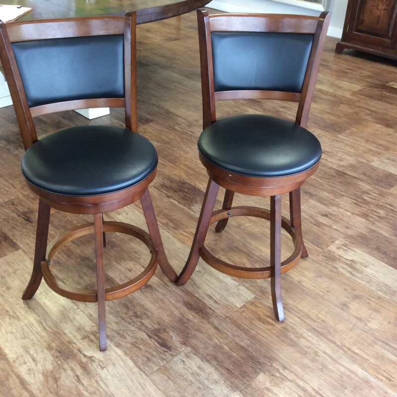 This pair of wooden counter height stools have a cherry finish with upholstered seats and backs,