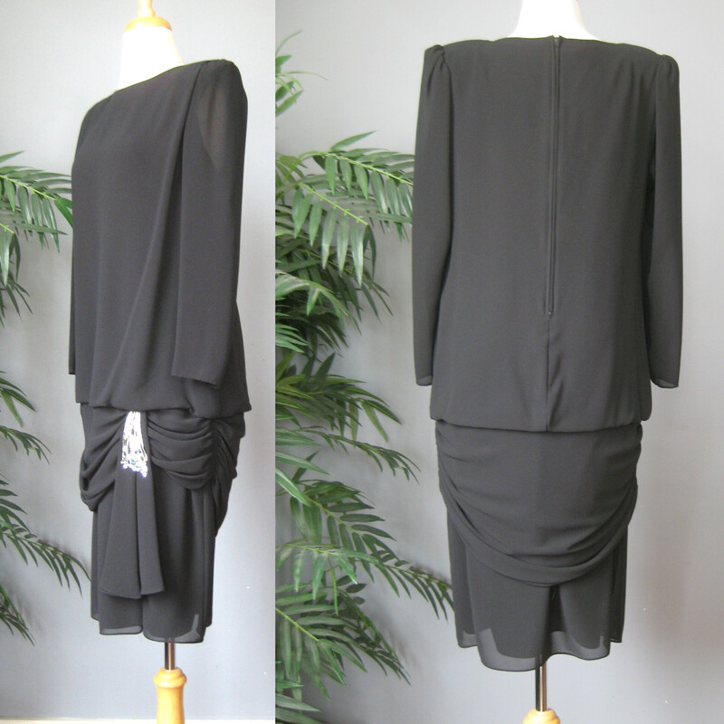 Vtg Ursula Cocktail, Black, Size: 12<br />
Black evening dress from the 1980s by Urusla<br />
It has big shoulder pads, a draped skirt and a pretty sequined swag at the left hip.<br />
Unlined with a center back zipper<br />
Made in the USA<br />
<br />
Marked size 12 but better for a modern size medium.<br />
Here are the flat measurements, please double where appropriate:<br />
Shoulder to shoulder: 15<br />
Armpit to Armpit: 19.75<br />
Waist: 18<br />
Hips: aprox 20<br />
Length from back of neck to hem: 41<br />
Underarm sleeve seam: 17<br />
<br />
Excellent condition, no flaws!<br />
Thank you for looking.<br />
#69135