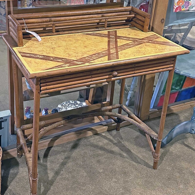 MCM Writing Desk,
Size: 31x19x30
This desk has one drawer and a gallery on the top to hold stationary.  The top is painted with a geometric pattern.