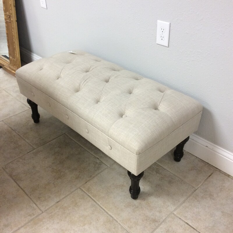 Very nice! This could be used as an ottoman at the end of a bed or a bench. It's tradiitonal and timeless in design. It's been upholstered in a soft beige with button-tufting.