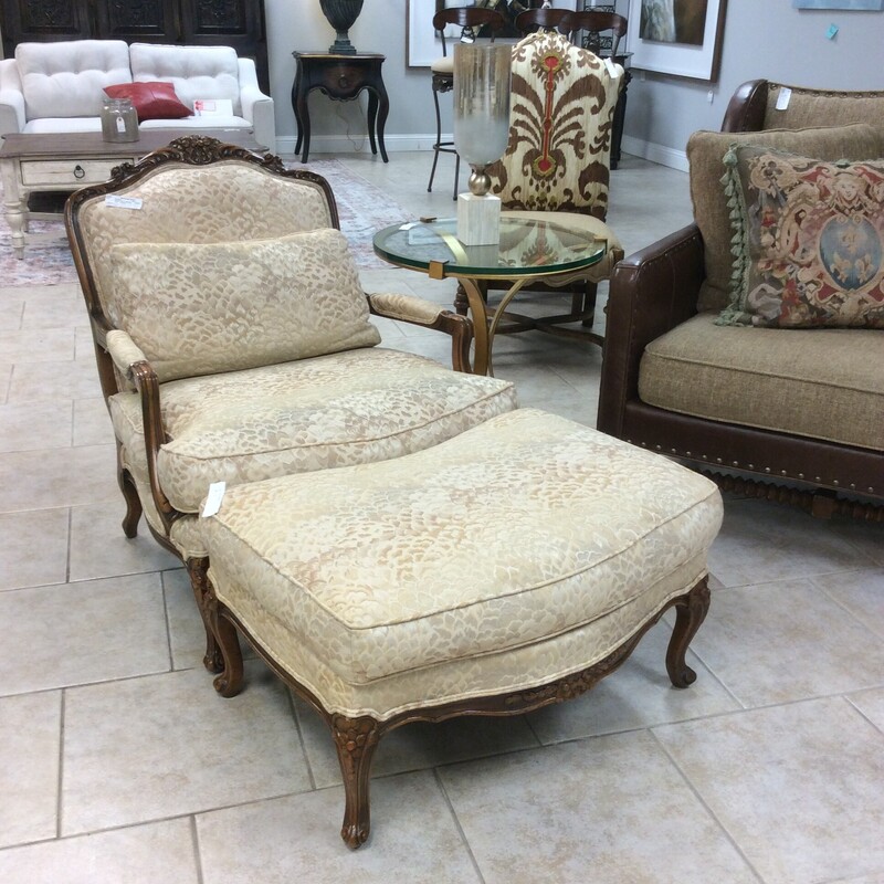 This 2 piece set is very traditional in style. The wood frame has nice carved details and a dark wood finish. Both pieces have been upholstered in a shimmery gold, silver, cream and white patterned fabric. We have a pair of these  priced separately.