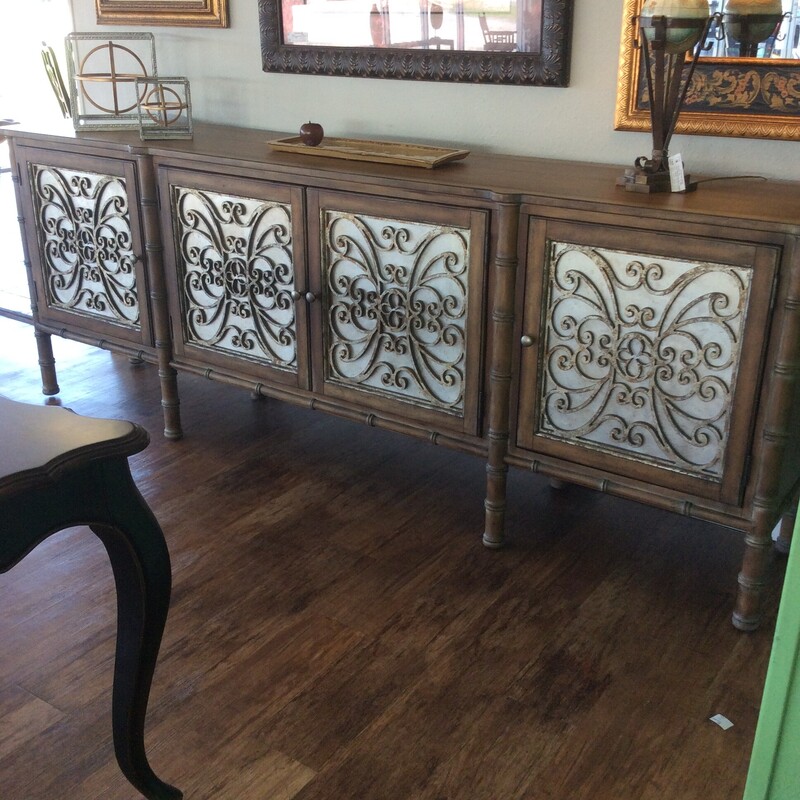 This impressive Console Cabinet by Hooker Furniture has metal scroll work door panels and a custom stained finish.