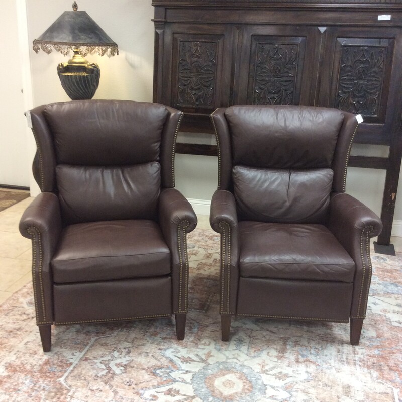 This pair of  Motioncraft Recliners are upholstered in brown leather with nail head trim.