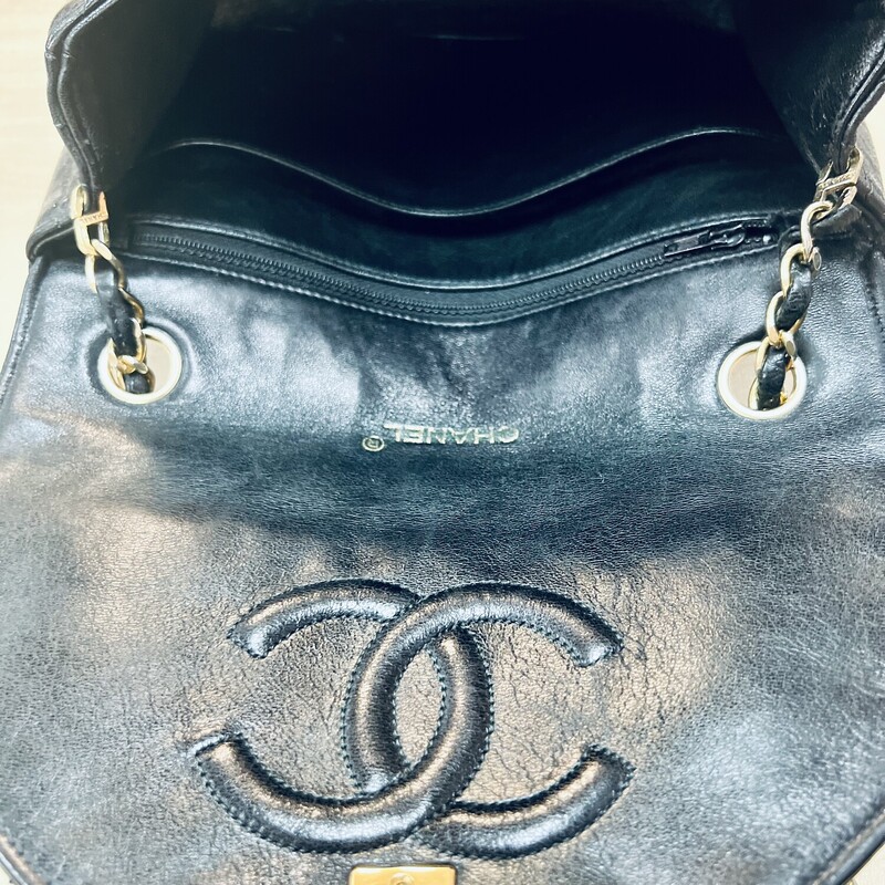 CHANEL<br />
Classic Vintage Chanel Round Flap Quilted Leather Black Shoulder Bag<br />
Details: Estimating It is From Late 80s/90s<br />
 Single Chain Gold Hardware<br />
Height 6\" With Flap Closed Width 9\" Depth 2.5\" Shoulder Drop 19.5\"<br />
In great condition, minor wear to chain and interior.<br />
If you ever wanted a piece of Authentic Chanel this is your chance.