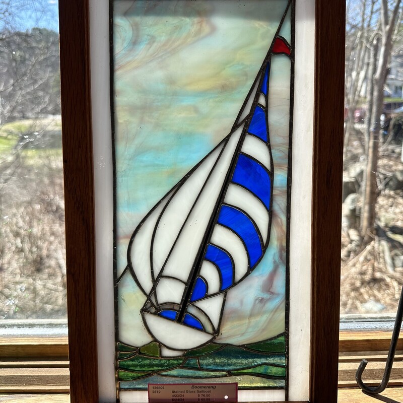 Staine Glass Sailboat,
 Size: 10 X17
Beautiful hand made stained glass sailboat in wood
frame.  Bright colors will pop in the right light.
