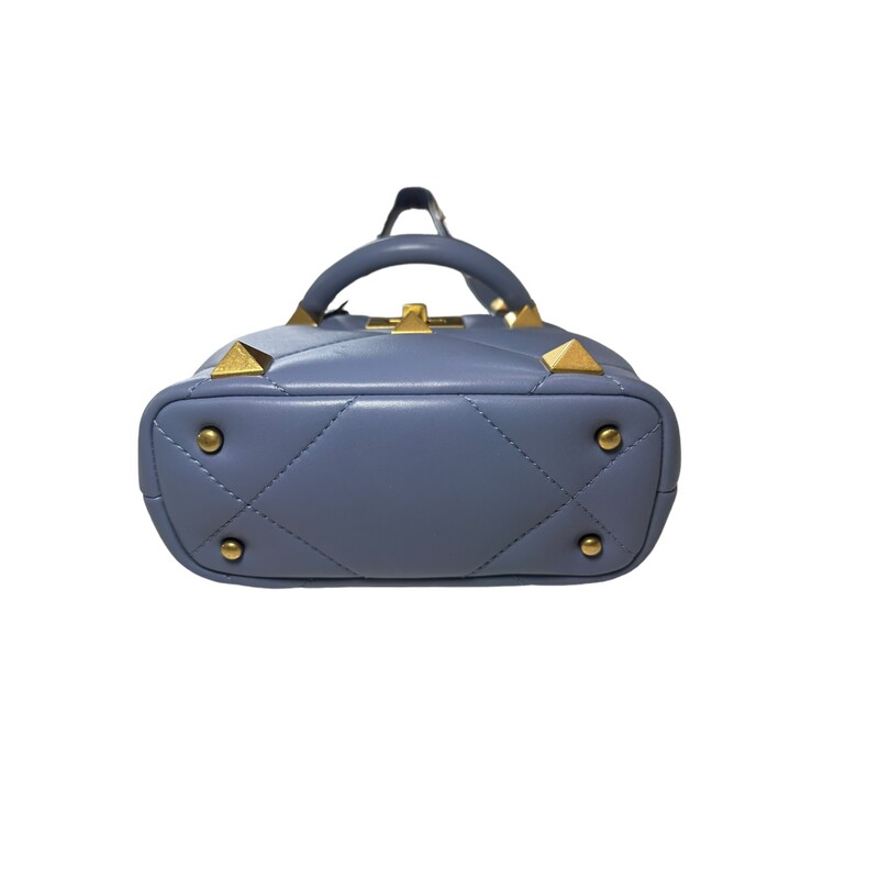 Valentino Roman One Stud<br />
Roman Stud Top Handle Bag Quilted Leather Small<br />
Exterior Material: Leather<br />
Exterior Color: Blue<br />
Interior Material: Leather<br />
Interior Color: Blue<br />
<br />
Hardware Color: Aged Gold<br />
<br />
Dimensions: : Handle Drop 4, Height 7, Width 7,<br />
Depth 5, Strap Drop 21