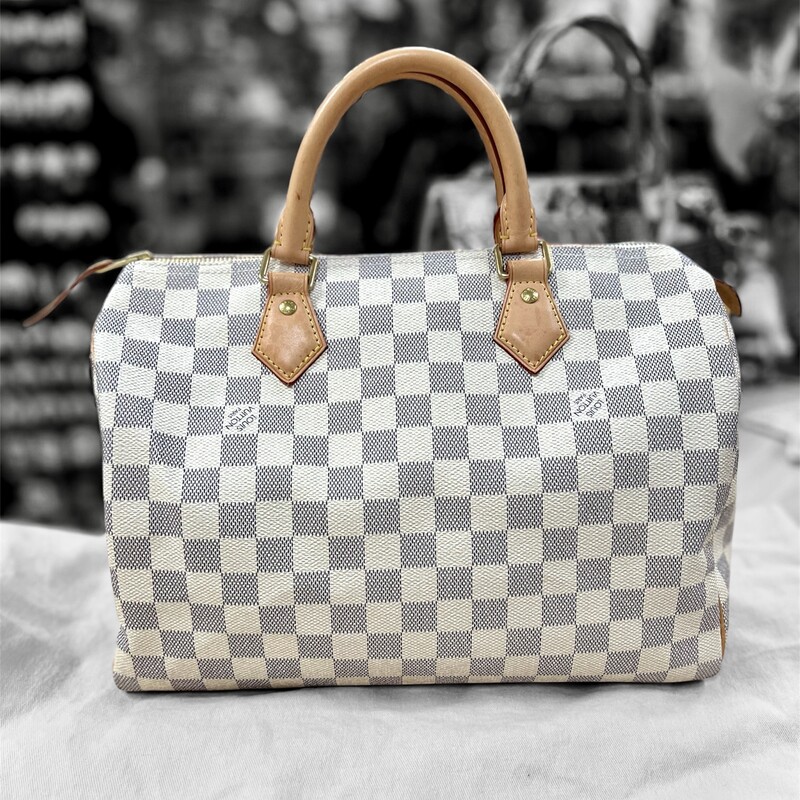 Authentic LOUIS VUITTON - SPEEDY 30<br />
Fashioned from luminous Damier Azur canvas, the Speedy 30 is an elegant, compact handbag, a stylish companion for city life. Launched in 1930 as the \"Express\" and inspired by that era's rapid transit, today’s updated Speedy remains a timeless House icon, with its unmistakable silhouette, rolled leather handles and engraved, signature padlock.<br />
<br />
SD2197 - indicates the bag was manufactured in France on 29th week of 2017<br />
<br />
11.8 x 8.3 x 6.7 inches<br />
(length x Height x Width)<br />
Damier Azur coated canvas<br />
Natural cowhide-leather trim<br />
Textile lining<br />
Gold-color hardware<br />
Padlock<br />
Inside zipped pocket<br />
D-ring<br />
Handle:Double<br />
Comes with the Original Dust Cover<br />
This bag retails $1550.00 Brand New.<br />
This bag is in great preowned condition, very minor wear.  Leather has not even started tanning yet.<br />
If you go online to Louis Vuitton you will find this bag is currently out of stock.