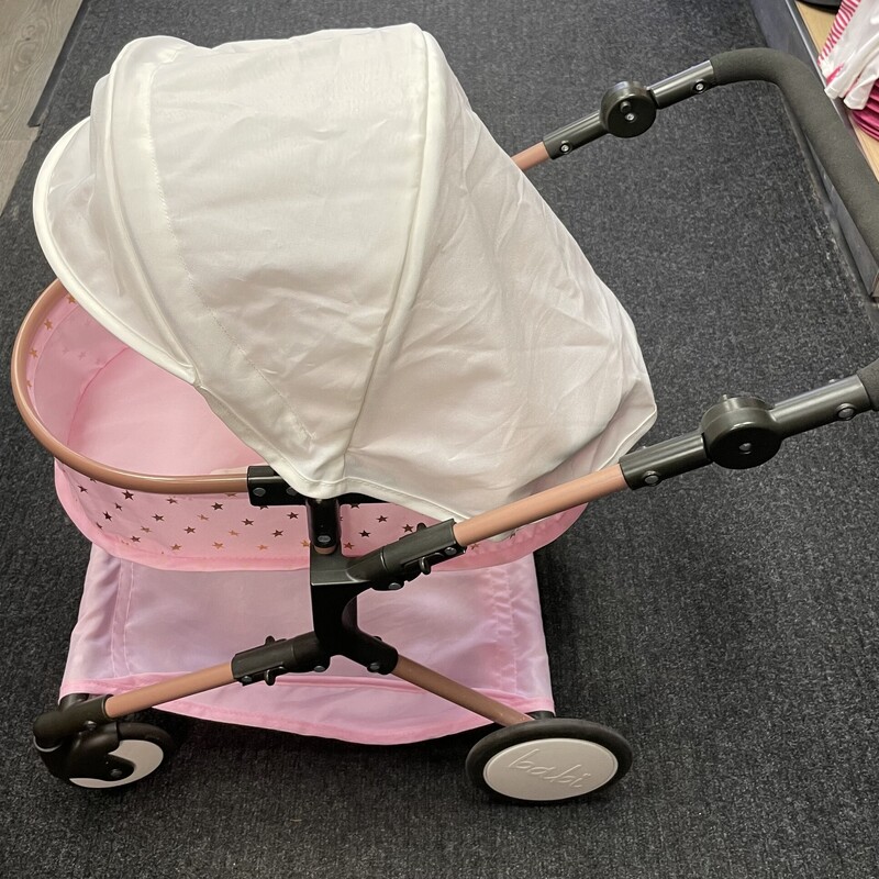 Babi Folding Twin Doll Stroller, Pink, Size: 14 Inch

Easy to fold and ready to push, take cuddly babi doll twins everywhere in the adorable babi double stroller.

It features an easy-to-grab foam handle that adjusts for various heights, with swivel front wheels and larger rear wheels to easily turn and steer. Perfectly sized for two 14-inch dolls, the foldable canopy and safety strap will keep babi twins comfy and secure. And the removable storage basket underneath helps keep babi's precious accessories nearby. Measuring 25 (H) x 17 (L) x 16.5 (W), the double stroller folds flat for convenient storage, is durable for everyday play, and the lightweight frame helps young nurturers travel to their favorite destinations