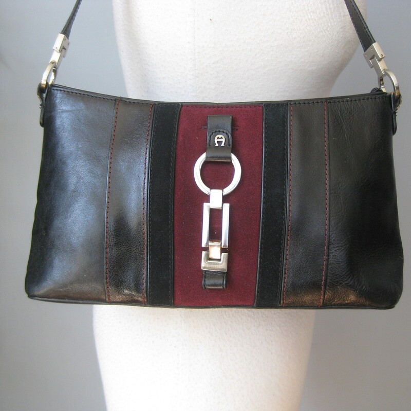 Vtg Etienne Aigner Shldr, Blk/burg, Size: None<br />
Handsome Etienne Aigner handbag in black leather with a wide burgundy suede stripe on the front.<br />
Silver hardware<br />
Central zippered pocket and two full size side pockets<br />
Inside there is one zippered pocket and one slip<br />
Great condition but the edge of the straps has some cracks as shown.<br />
<br />
Measurements:<br />
Width: 12<br />
Height: 7<br />
Depth: 3 1/2<br />
Handle Drop: 11.25<br />
<br />
Thanks for looking!<br />
#71947