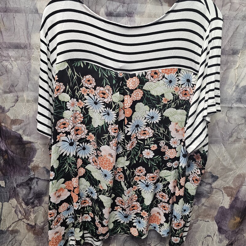 Cute short sleeve knit top with black and white striped front and floral back.