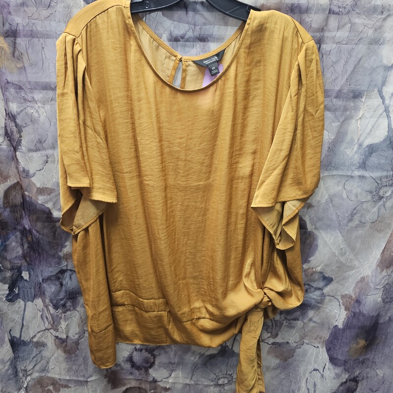 Super cute blouse in a silky material that is done in mustard yellow.