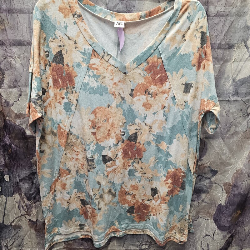 Super cute short sleeve tee in a light teal with floral design.