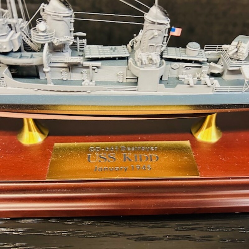Danbury Mint USS Kidd<br />
Grey Black Brown with Removable Acrylic Top<br />
Size: 15x4x6H<br />
Named after Rear Admiral Isaac C. Kidd, who was killed in action during the attack on Pearl Harbor, this ship is a testament to his bravery and sacrifice. Commissioned in 1981, the U.S.S. Kidd is a guided missile destroyer that has played a crucial role in various military operations, including the Gulf War and Operation Enduring Freedom.  Stunning 1:350 scale with Danbury Mint COA Included