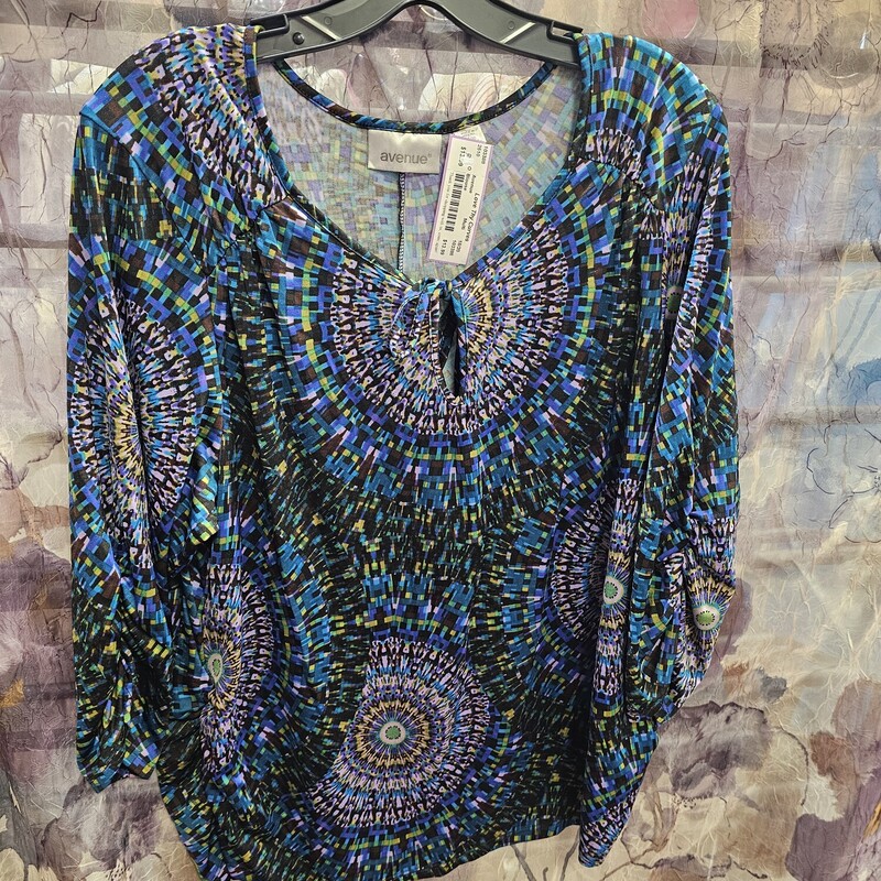 Fun half sleeve blouse that is sure to flatter in jewel tone mosaic pattern print.