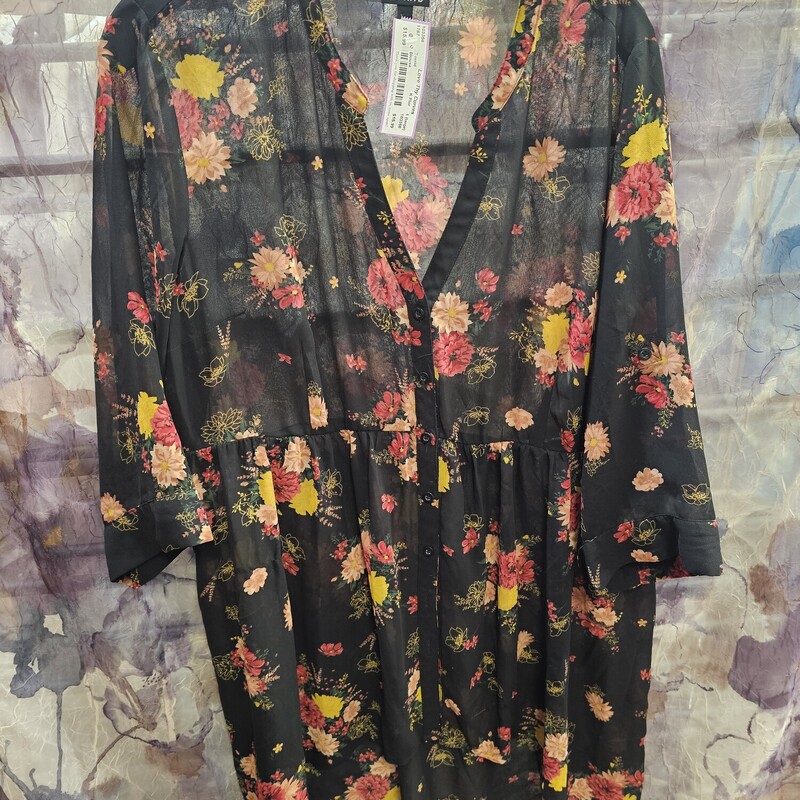 Sheer hi-lo blouse in black with floral print. Button up front.