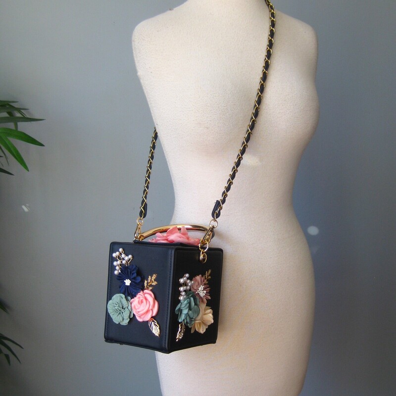 How pretty will this little bag look on the table at your next even?
It's a navy blue firm body box bag with pink and blue fabric flowers on the sides and the top.
Sturdy handle with gold accents and a removeable chain strap threaded with faux leather
Measurements:
width: 4.75 height: 6 3/8 depth: 6
Handle drop: 3.5
Strap drop: 20 (crossbody strap can be removed)

Perfect condition!
thanks for looking!
#71462