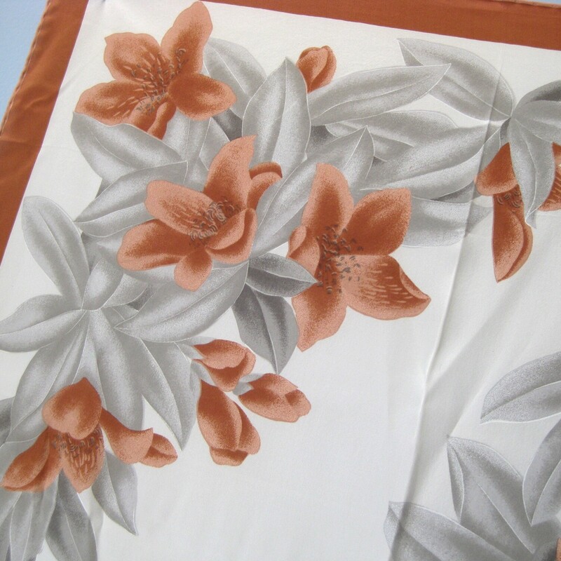 Very pretty square silk scarf in soft tannish orange and gray. cream center and touches of black<br />
The floral pattern features large scale lillies.<br />
Hand rolled edge<br />
it's signed, but I cannot make out the letters! Milren? Please help if you know, I would really appreciate!<br />
<br />
30 x30<br />
<br />
Thanks for looking!<br />
#65691