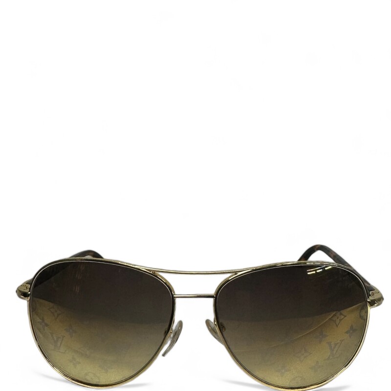 Louis Vuitton Pilote Avia, Gold, Size: OS

Dimensions:
Length: 5.50 in
Height: 2.00 in

This is an authentic Louis Vuitton Monogram Conspiration Pilote Sunglasses Z0164U in Gold. The exquisite detailing and bold style of these Louis Vuitton sunglasses makes them a fabulous fashion accessory. These are classically styled aviator sunglasses with gold metal frames. The lenses are a gradient shade of brown with a shadowy Louis Vuitton monogram across them that can be seen through.