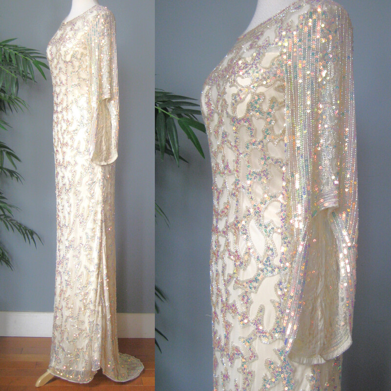 You are a shimmering goddess in this long extremely fancy HEAVY white gown by Primavera.
It's lavishly beaded and sequined with irridescent clear and peach sequins and clear beads.
It has a small train at the back
The sleeves are long in the back and shorter in the front, giving almost a renaissance feel.

Marked Size 12 but it may well not work for a modern size twelve, so please use the garment's actual measurements provided here. And let's chat if you need help determining if it will work for you. You will want the gown to fit to the body but there is not any stretch. It had a side zipper

Flat Measurments:
shoulder to shoulder: 14
Armpit to Amrpit : 19
Waist: 14.5
Hips: 18 you want it close here, and because of the bias cut, there is some give here, so you could probably get it on if your hips are 40 around or less.
Length: 61 in the front and about 72 in the back. a little bit of this length will be taken up by the body filling out the hips.
Sleeves: 13.5 in the front 18 in the back.


Thanks for looking!
#69200