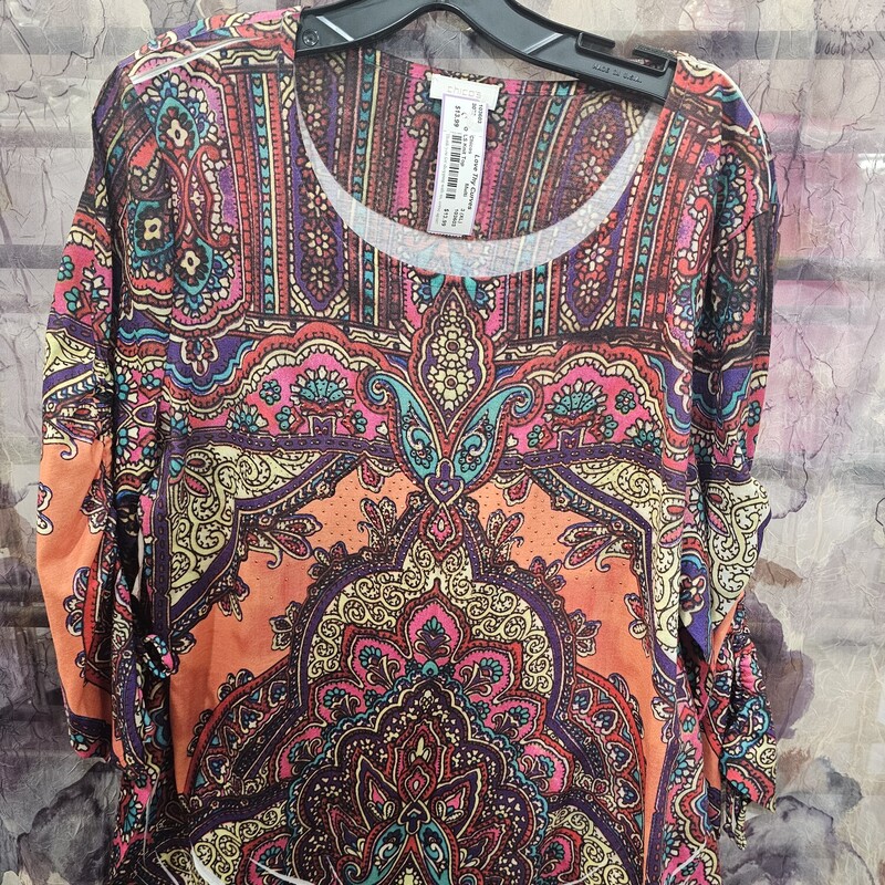 Half to three quarter sleeve knit top in a multi colored design and lots of bling.